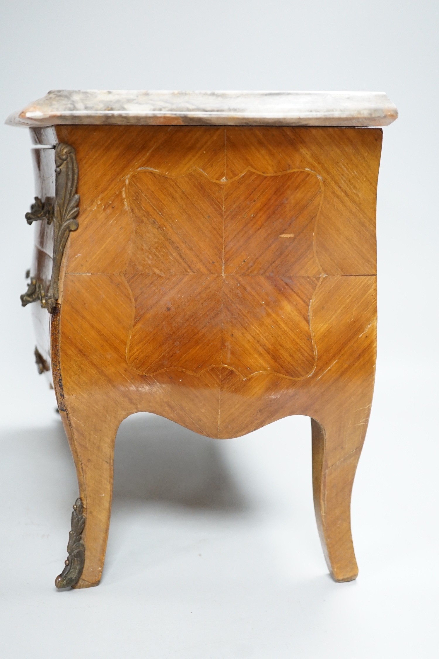 An Apprentice piece: Louis XV style miniature bowfronted French chest, with gilt mounts and pink and grey marble top. 27cm tall, 36cm wide, 17cm deep